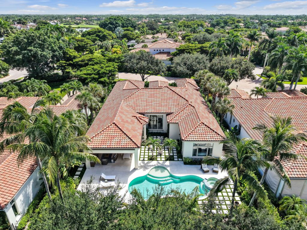 Aerial view of the backyard, pool, and lake