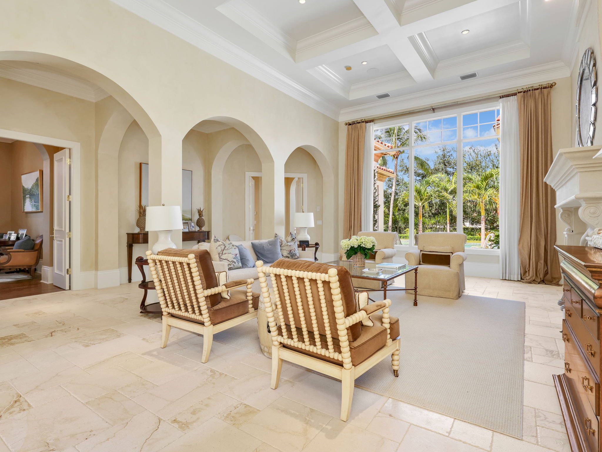 Living room with tray ceiling, fireplace, and picture window