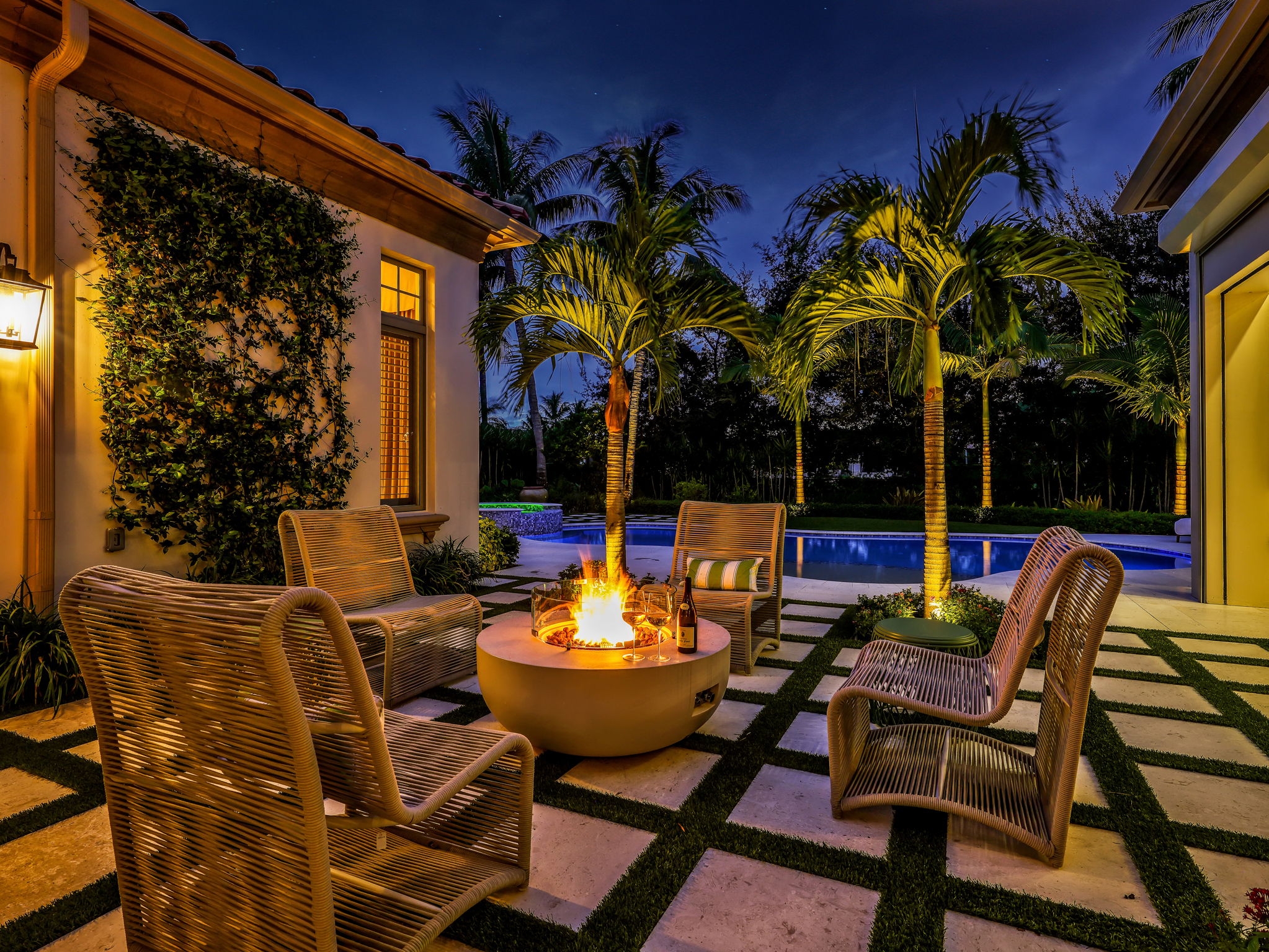 Firetable lounge at dusk with pool and spa beyond